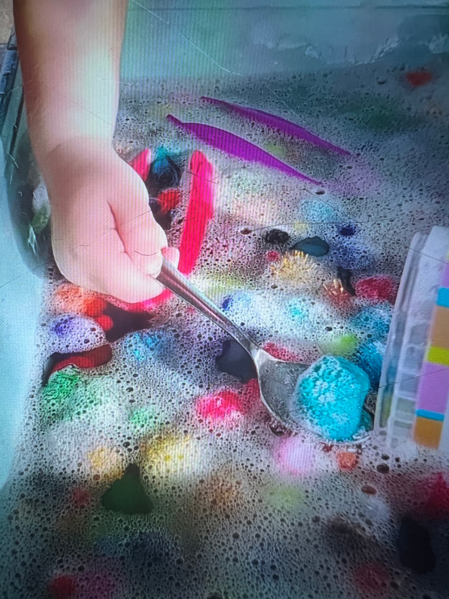 Lines of pink and purple paint drawn through foam